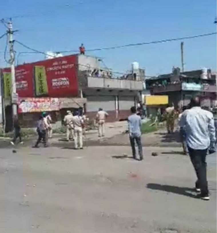 migrant laborers pelted stones at police
